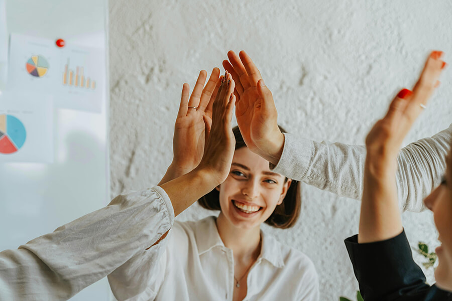 Afbeelding van medewerkers die elkaar een high-five geven. Het is gelukt!